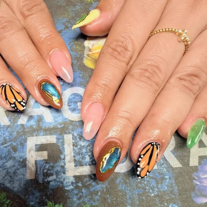 Orange butterfly-wing nail art by Nini Nail Bar
