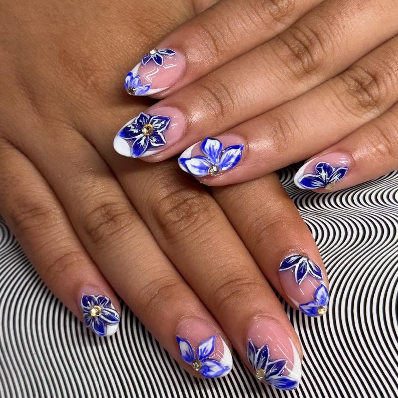Hand-painted blue floral nail art by Nini Nail Bar