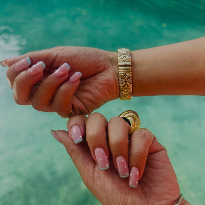 Soft pink almond nails with burgundy accents by Nini Nail Bar