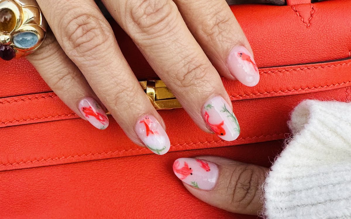 Sheer pink almond nails with hand-painted red koi fish by Nini Nail Bar