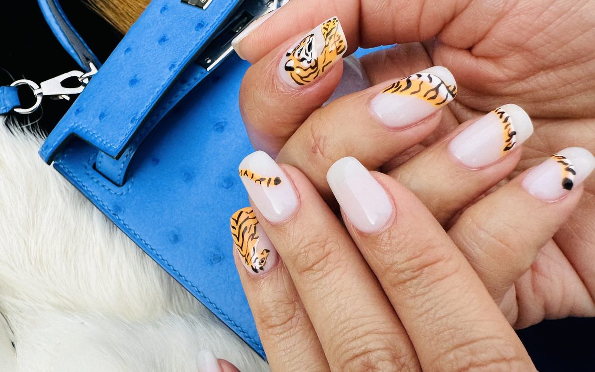 Milky white square nails with hand-painted tiger art by Nini Nail Bar, worn with a jade heart ring